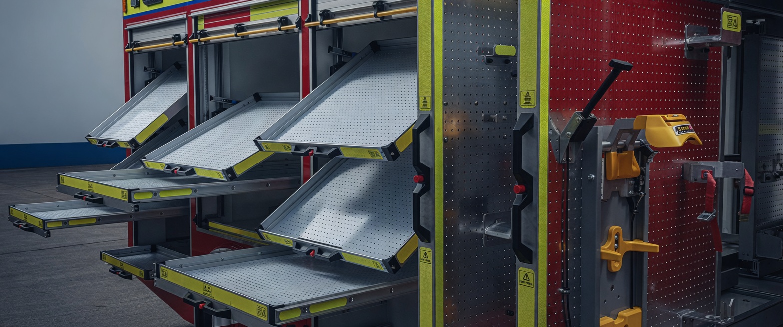 Fire appliance lockers with slide-tilt trays and vertical tool wall