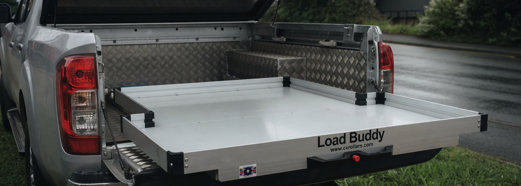 Load Buddy aluminium pickup drawer fully extended from a chequer-plate bed